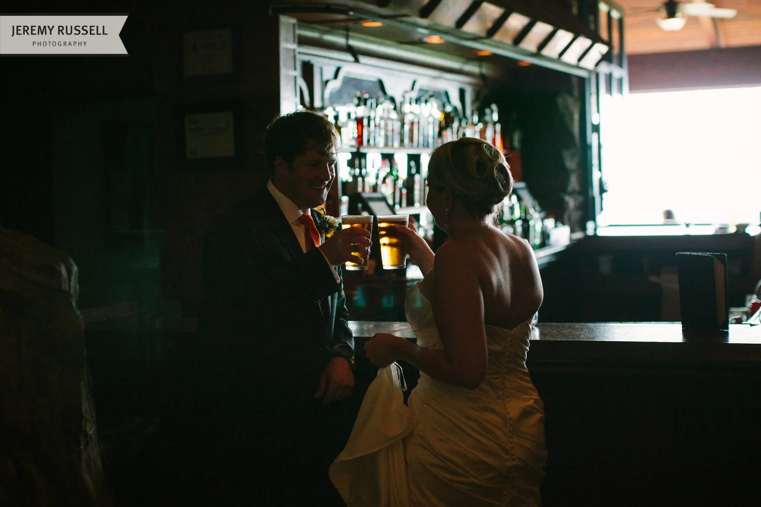 Bride and groom share a beer at Grove Park Inn