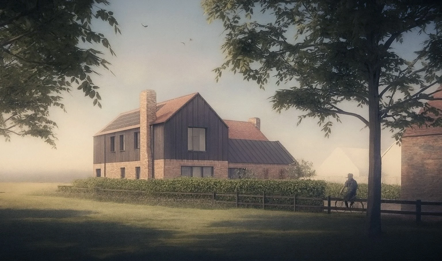 A house with a sloped red roof, brick base, and dark wooden upper story, surrounded by trees and greenery, with a person riding a bicycle nearby in a peaceful outdoor setting.