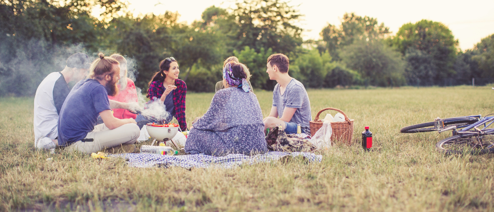 casual bbq picnic with friends at sunset.png