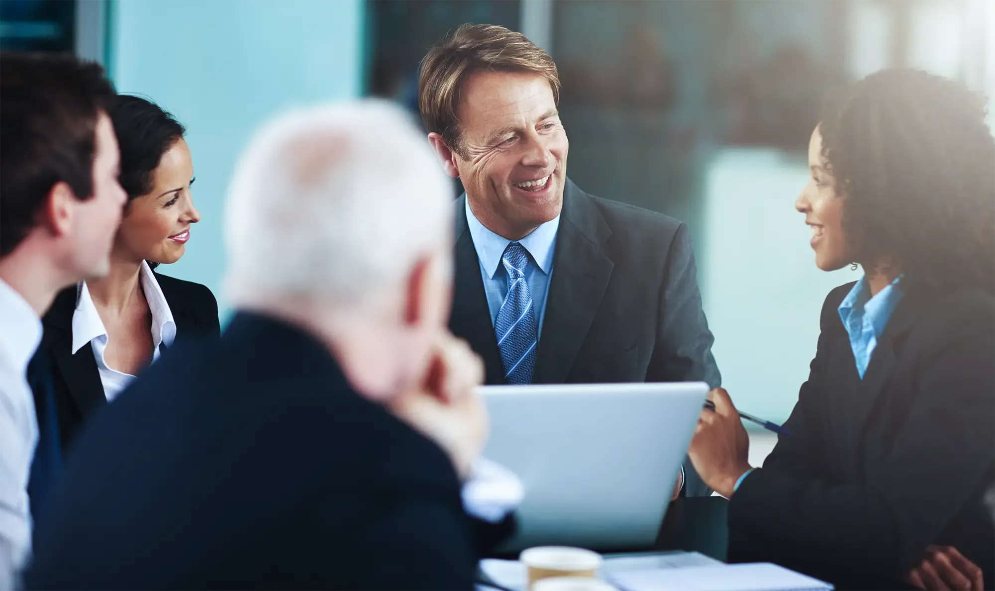 A group of business professionals having a discussion in a meeting room