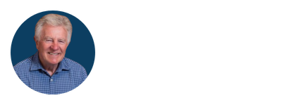 Headshot of Rene Boer, author of 'how to be a great boss' wearing a blue checkered shirt, against a dark background.