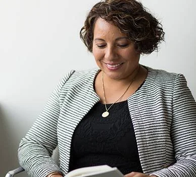 Woman entrepreneur reading book for business development and professional growth