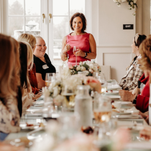 Andrea Liebross speaking at women's leadership dinner event