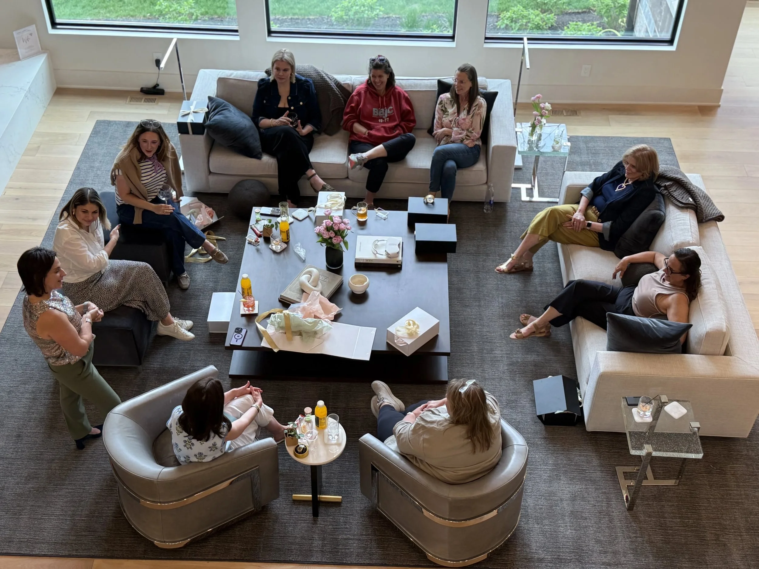 Women seated in a small group discussion in a living room during the She Thinks Big retreat.