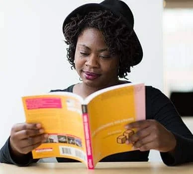 Woman business owner reading book for leadership development