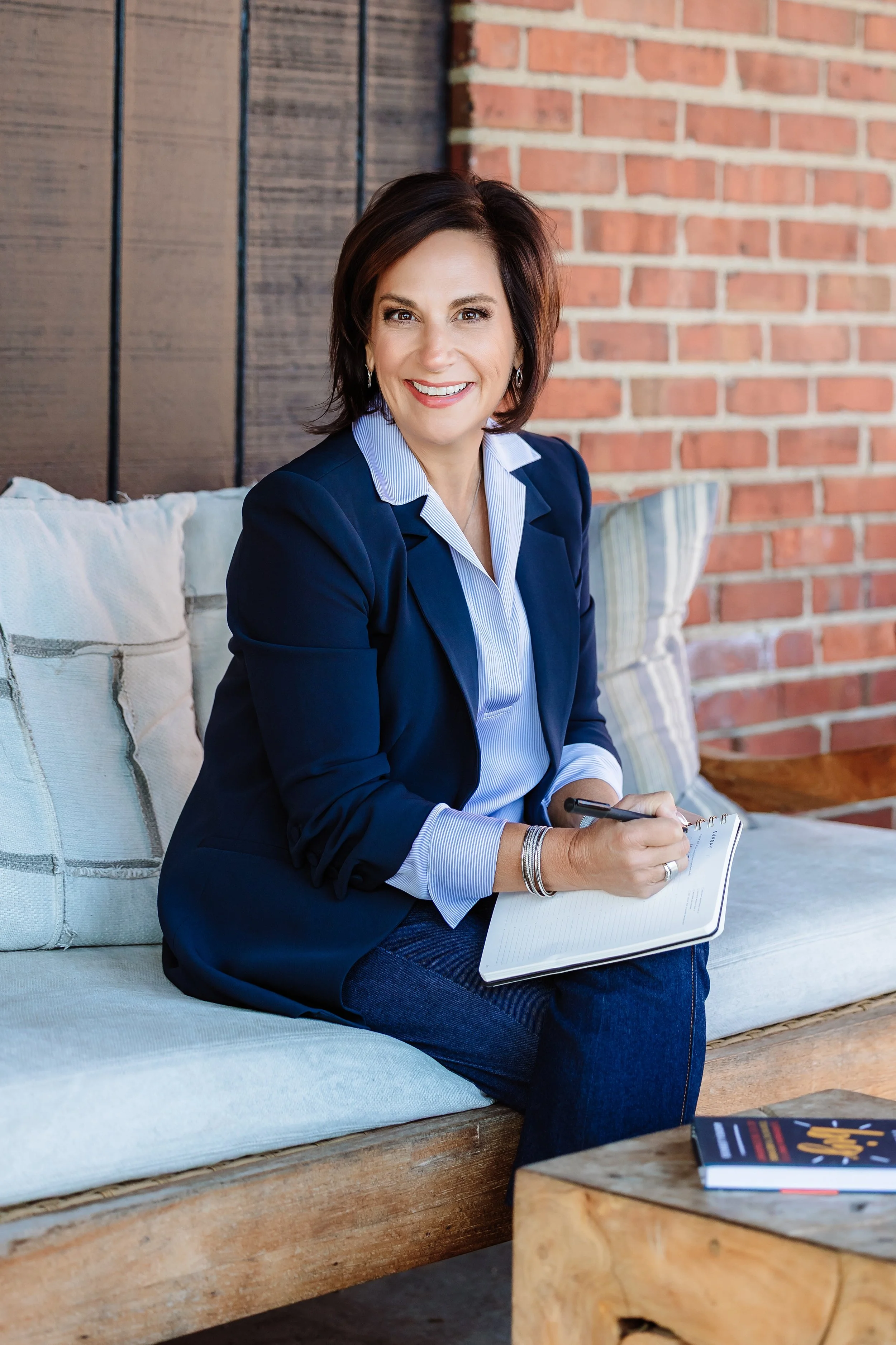 Andrea Liebross business coach for women business owners working with notebook outdoors