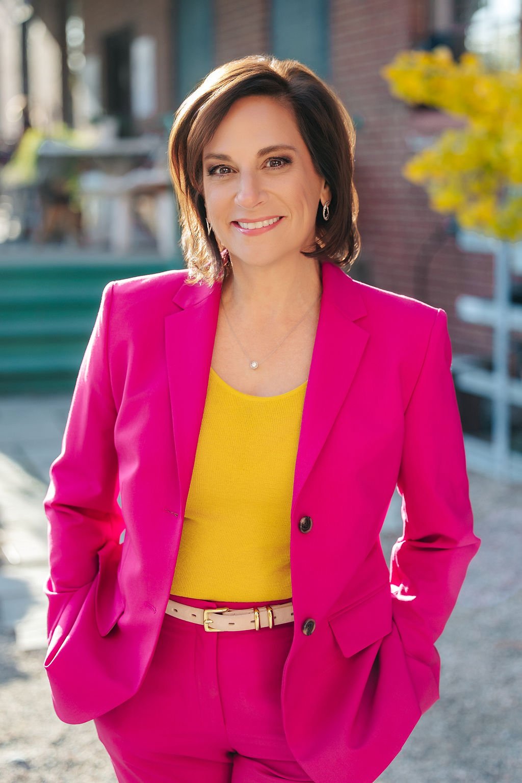 Andrea Liebross keynote speaker and business coach for women leaders wearing signature pink suit