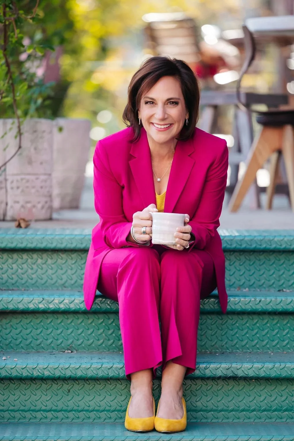 Andrea Liebross business coach for women entrepreneurs relaxed outdoor photo with coffee