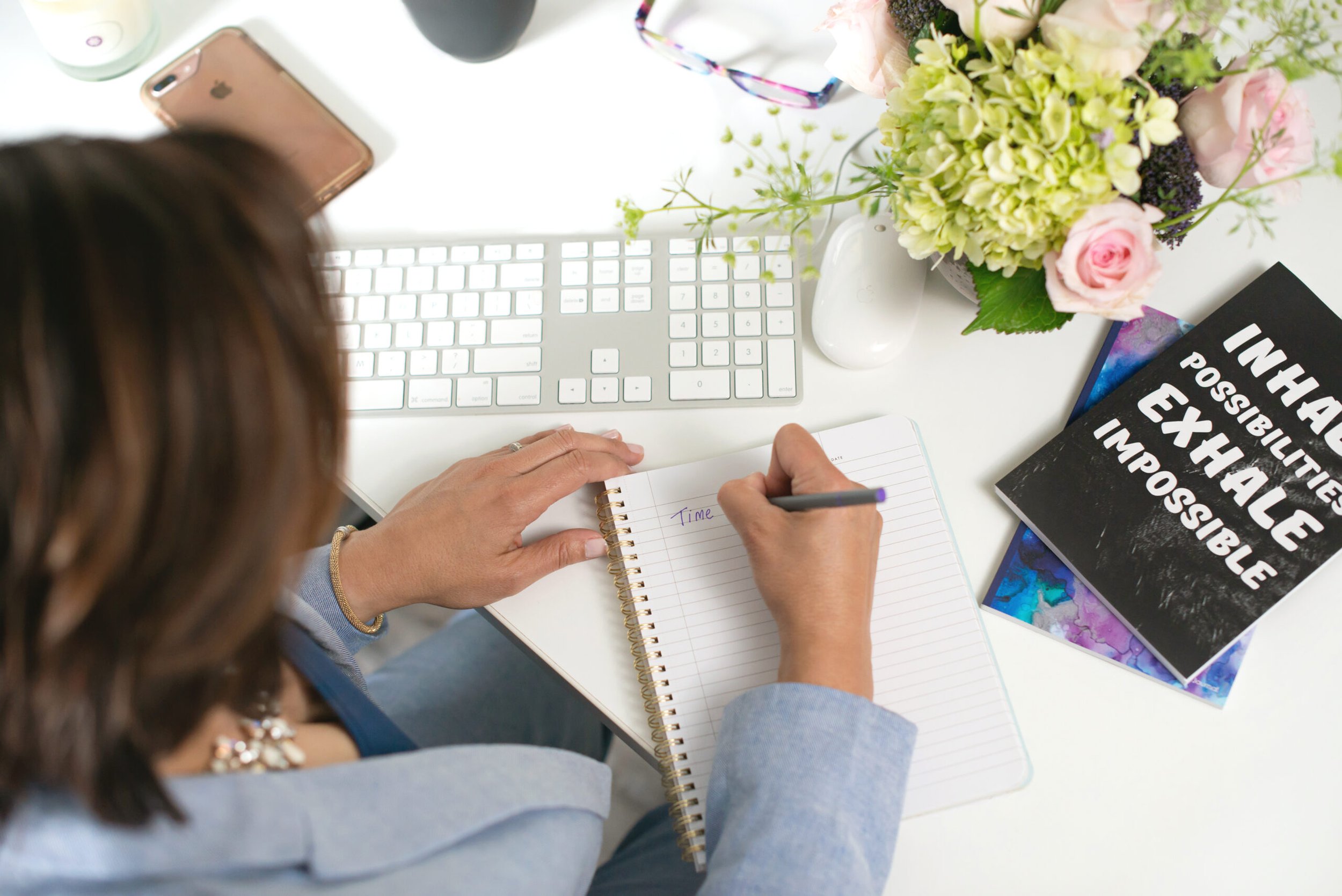 Woman entrepreneur planning business strategy with notebook and laptop