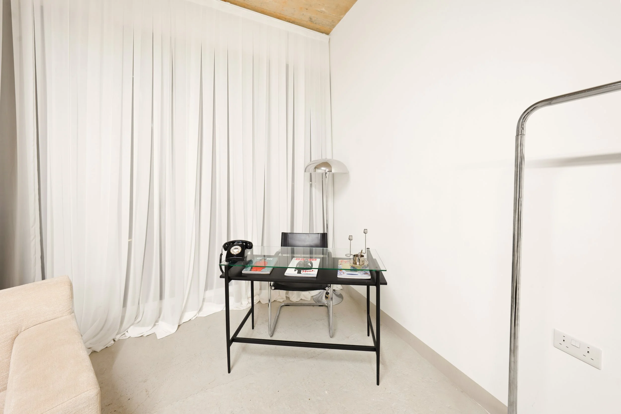 A modern office-style photography set at Urbn Link Studios in East London, featuring a professional workspace with contemporary furniture, neutral interiors, and versatile styling—ideal for corporate headshots, business branding, commercial photograp