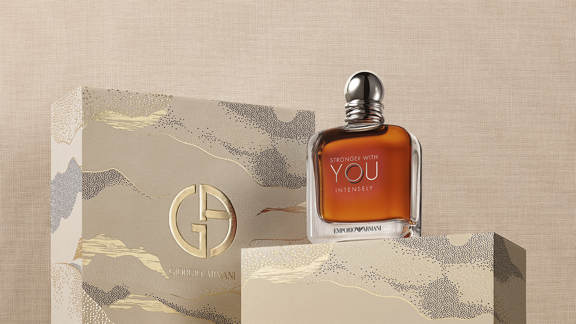ARMANI Ramadan Stronger With You _ Une bouteille de parfum Giorgio Armani à côté d'une boîte élégante, avec un fond beige et une texture sobre.