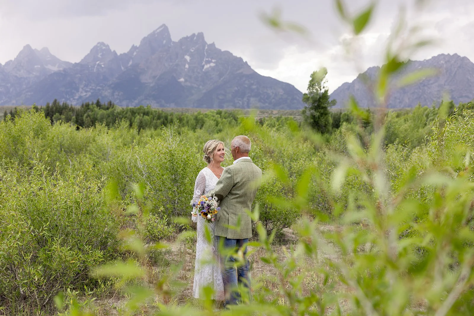 Eloping couple sharing their vows in front of the Grand Tetons near Jackson, Wyoming