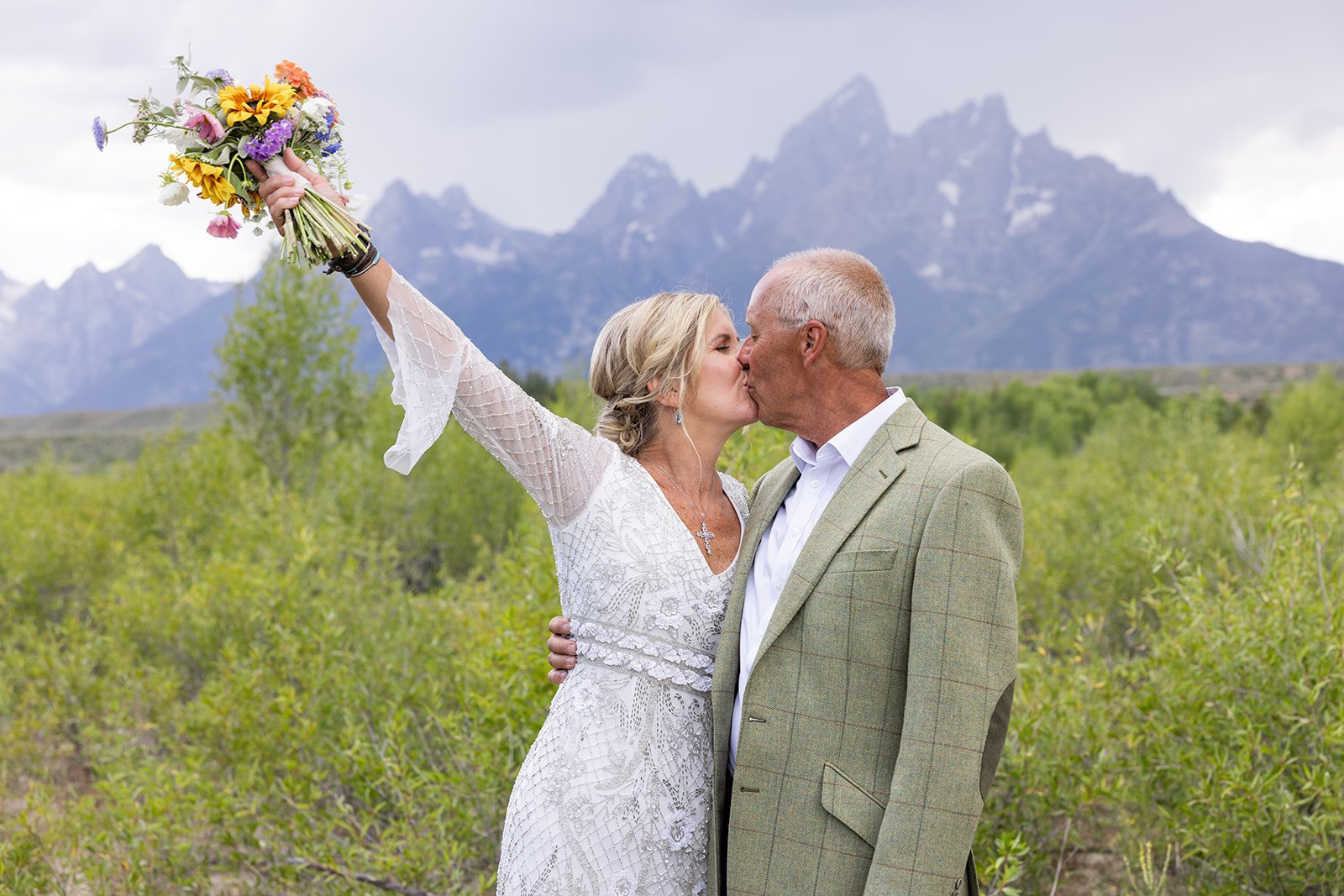 Bride and groom celebrating their elopement with a kiss in Grand Teton National Park
