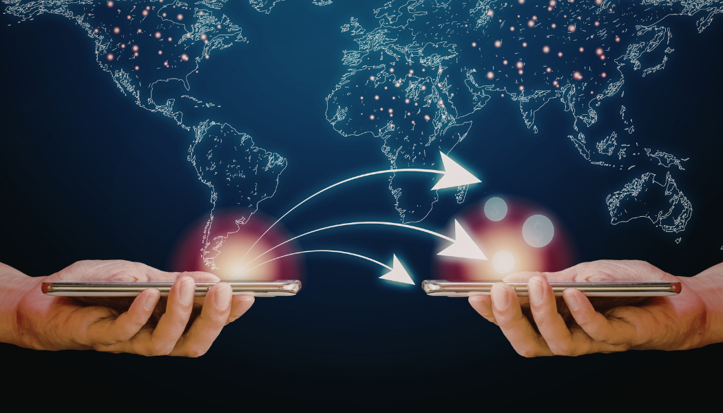 Two hands holding smartphones with a world map and arrows indicating data transfer between the devices.