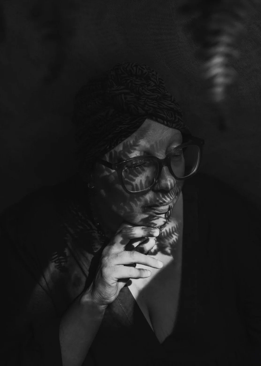 Carly Bedwell, photographer behind Fern & Wild Photography in Hertfordshire, photographed in black and white with fern shadows.