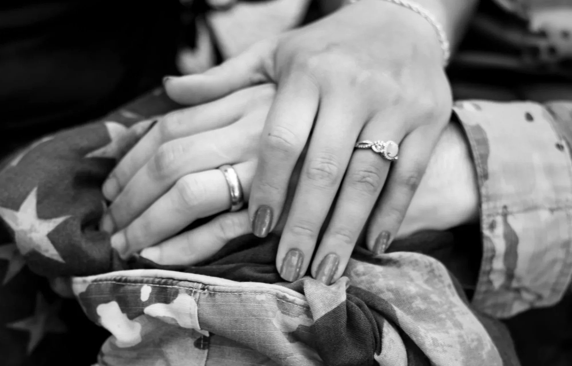 Detail shot of a couple holding hands during a lifestyle portrait session by Lightkeepers Photography.