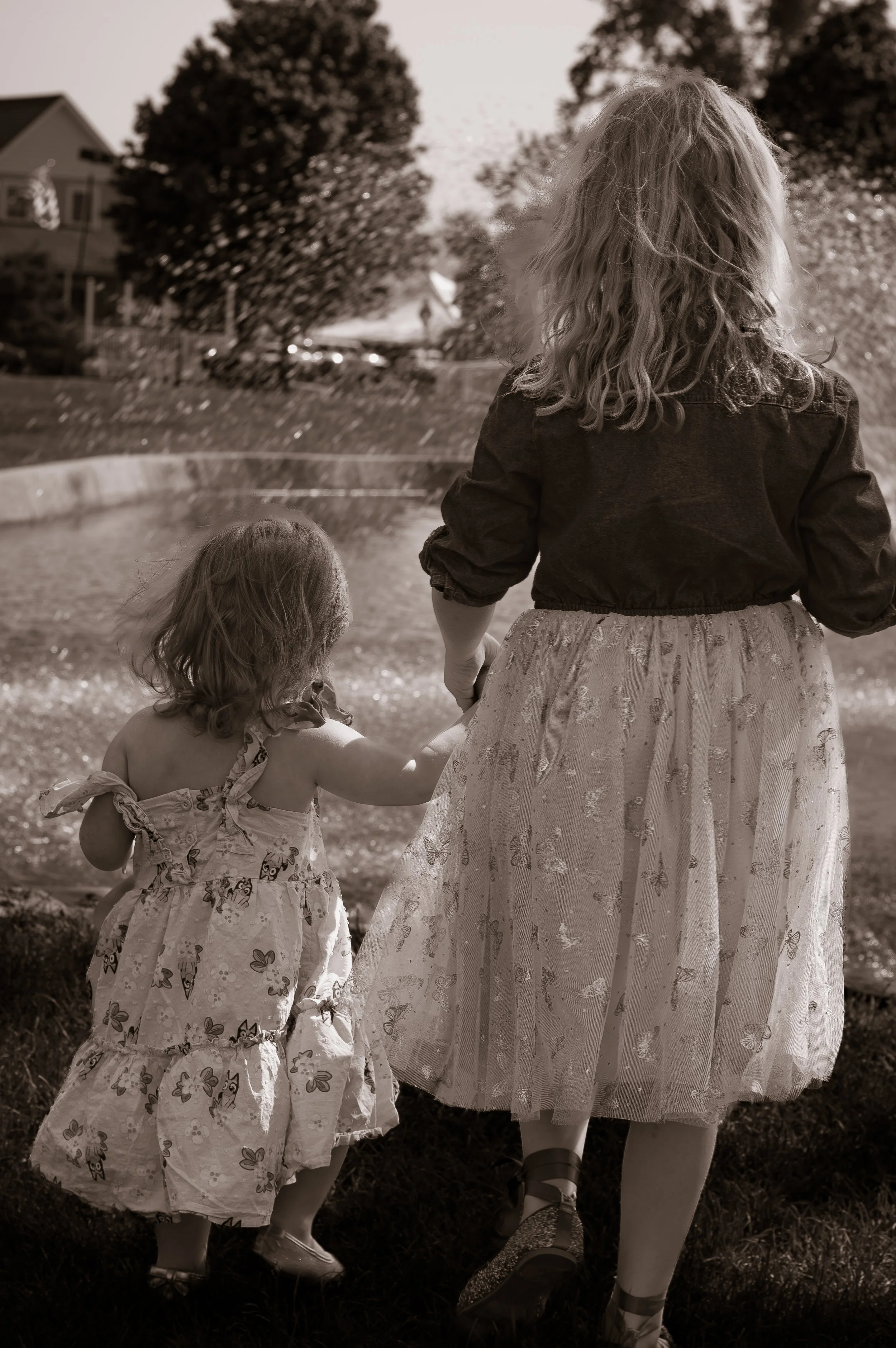 Candid outdoor portrait of two sisters during a family photography session in Northern Indiana.