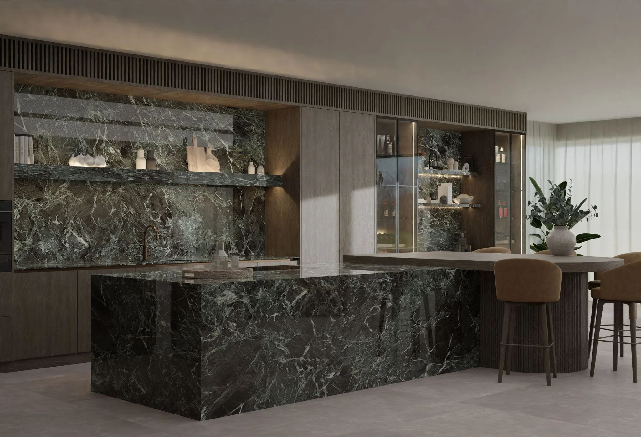 Modern kitchen with dark green marble countertops and backsplash, wooden cabinetry, and a dining area with beige chairs and a vase with greenery