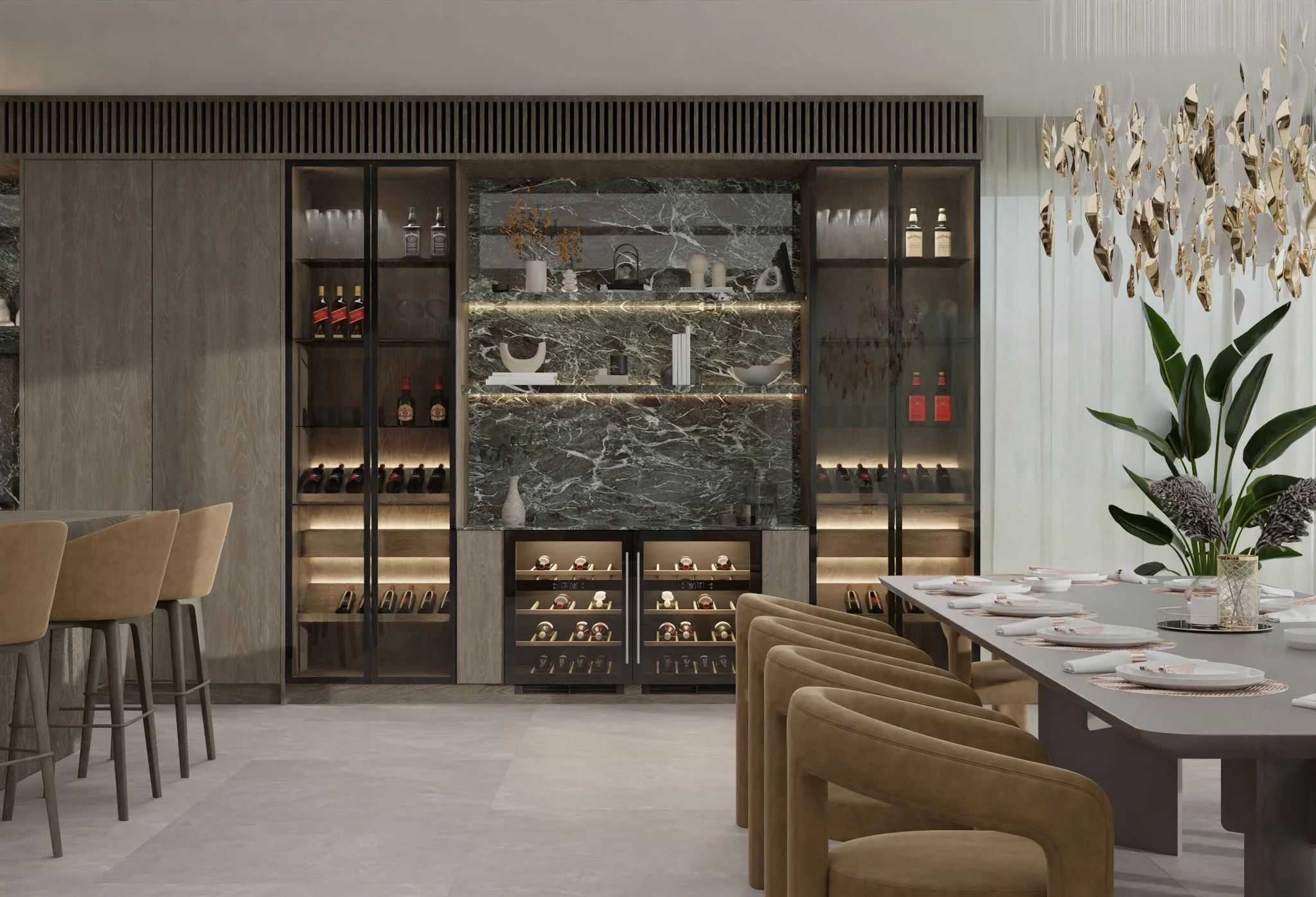 Elegant dining room with a long table set for a meal, surrounded by tan upholstered chairs. A large decorative light fixture hangs overhead, and there are white curtains on the window. The back wall features a built-in display with shelves and wine s