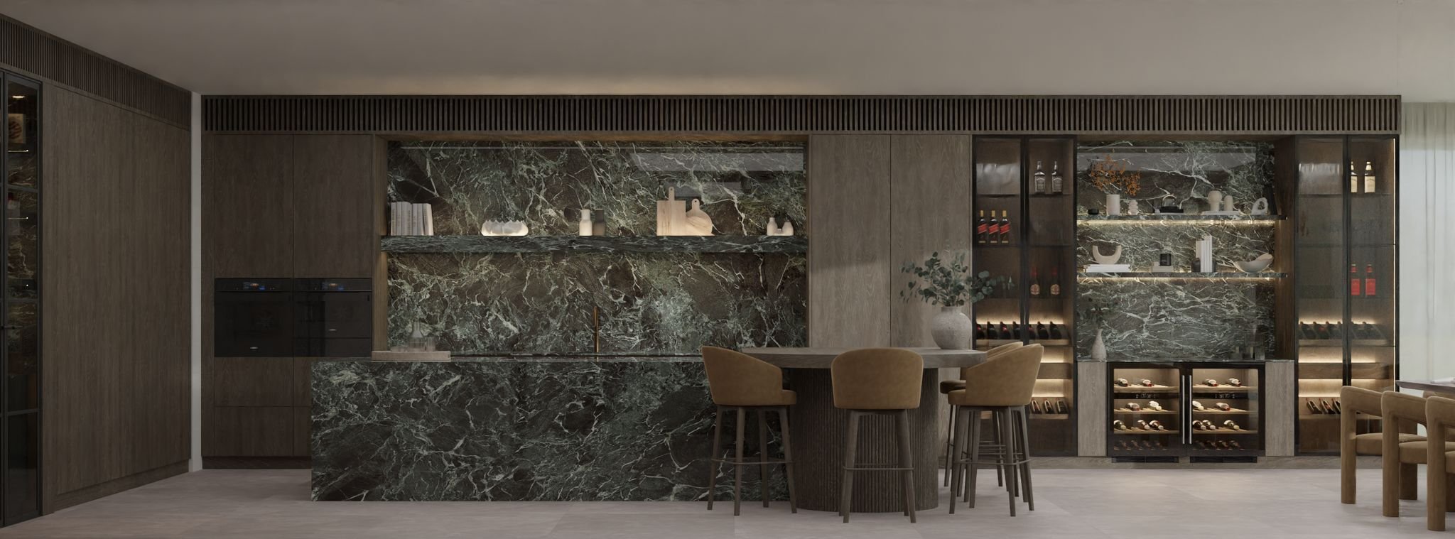 Modern kitchen with dark green marble countertops and backsplash, wooden cabinets, and glass display cabinets filled with decorative items and wine bottles, with a round dining table and beige chairs.