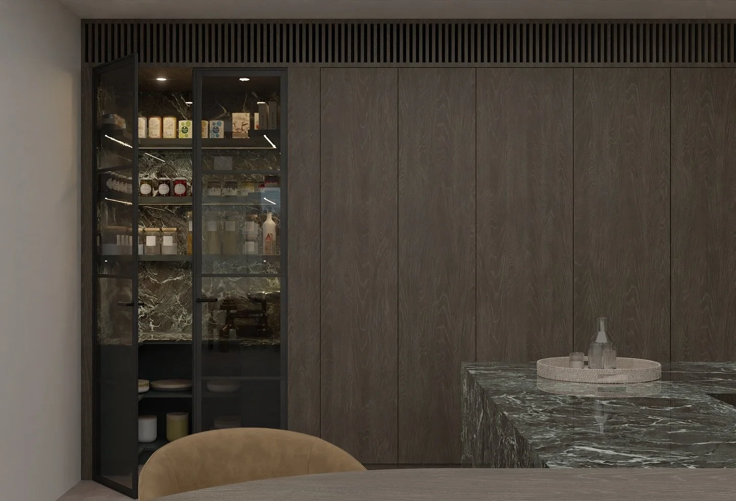 Interior view of a modern kitchen with a dark marble countertop, glass display cabinet with food jars and bottles, and wooden wall panels.