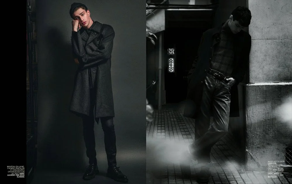 A split image of a young man. The left side shows him standing against a dark indoor background, dressed in a dark coat, pants, and boots, with one hand on his temple. The right side shows him leaning against a concrete wall in an outdoor urban setti
