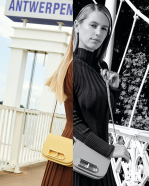 Stylish woman with blonde hair wearing a dark ribbed turtleneck sweater, standing on a bridge with trees in the background.