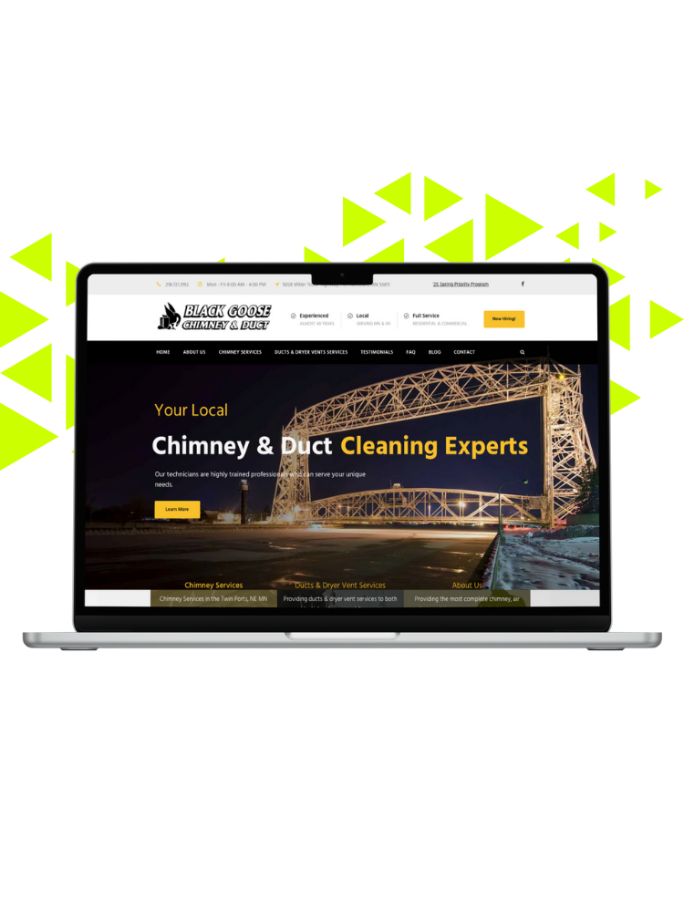 Laptop displaying a website for Black Goose Chimney & Duct Cleaning Experts with an image of a large illuminated bridge at night.