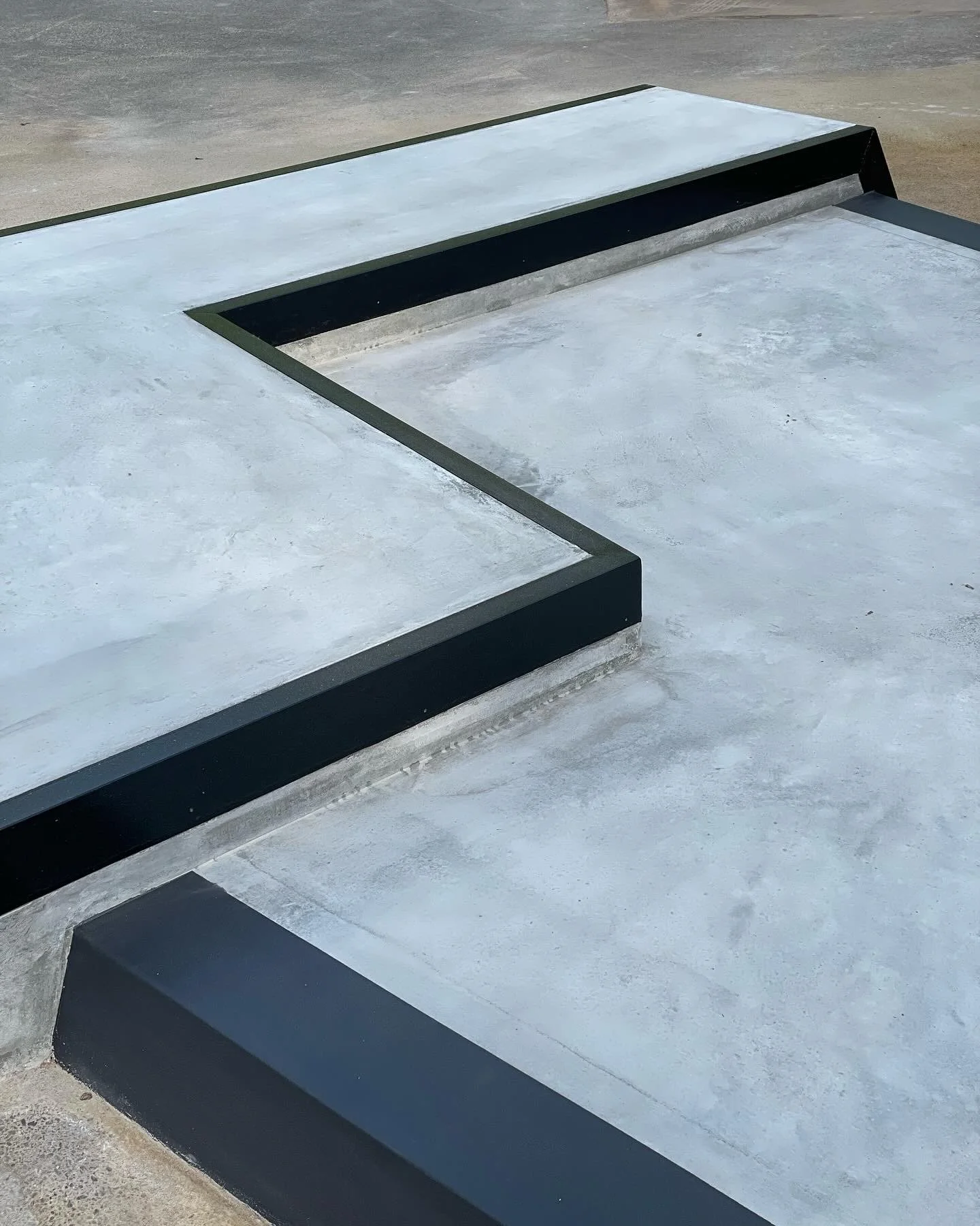 Burnished trowel finish concrete panels with steel edges. A burnished finish comes from repeated passes with a steel trowel. Each pass compresses the surface more, reducing dusting and improving wear resistance. #anl&auml;ggning #utomhusmilj&ouml; #b