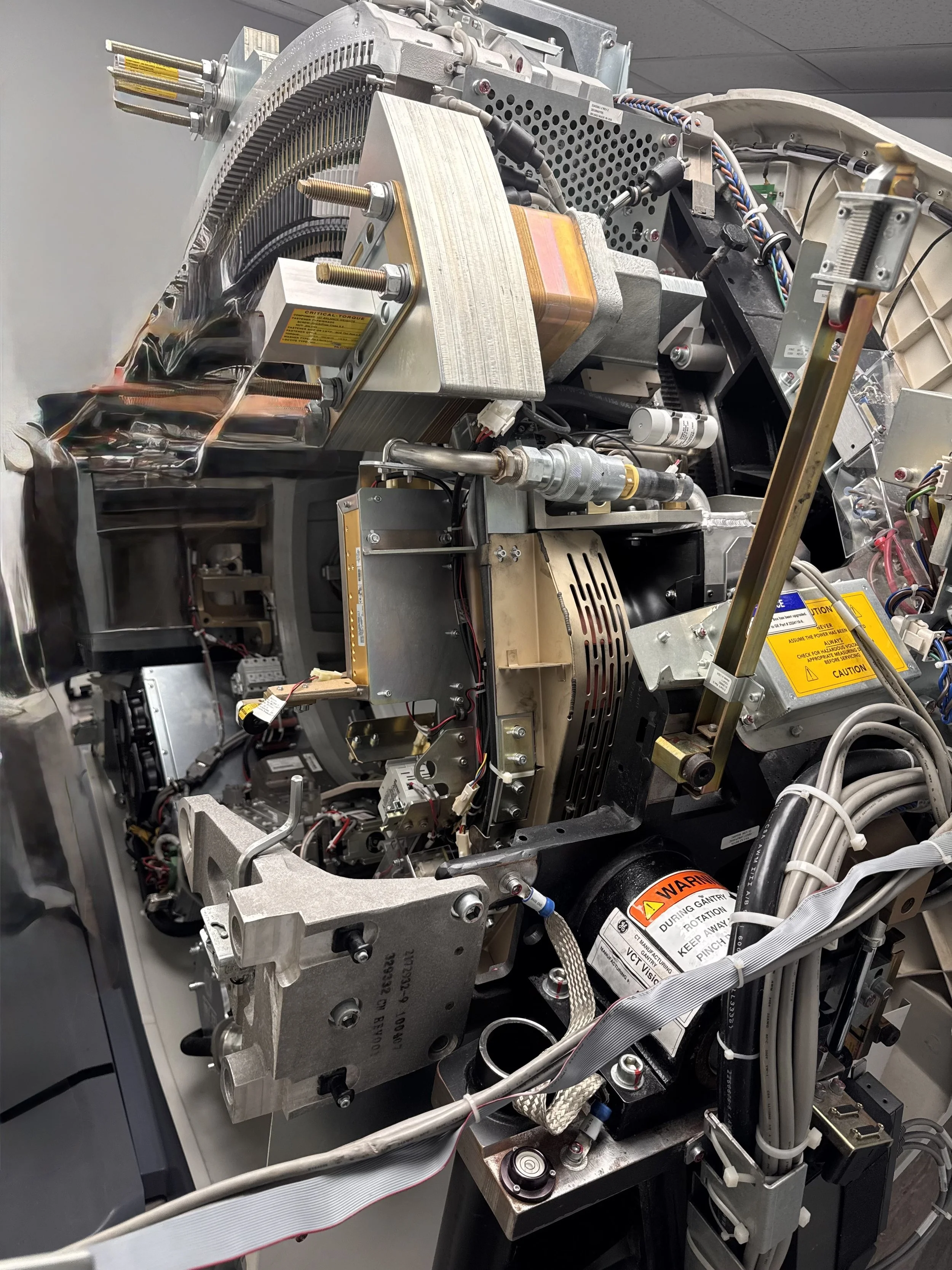 Detailed view of a complex piece of scientific or medical equipment with various metallic components, wiring, and electronic parts.