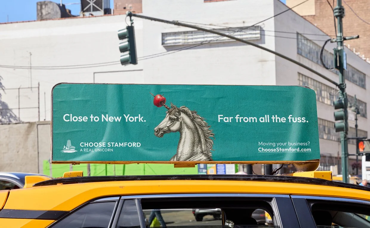 stamford ct, new york city, taxi advertisement, unicorn with apple on head