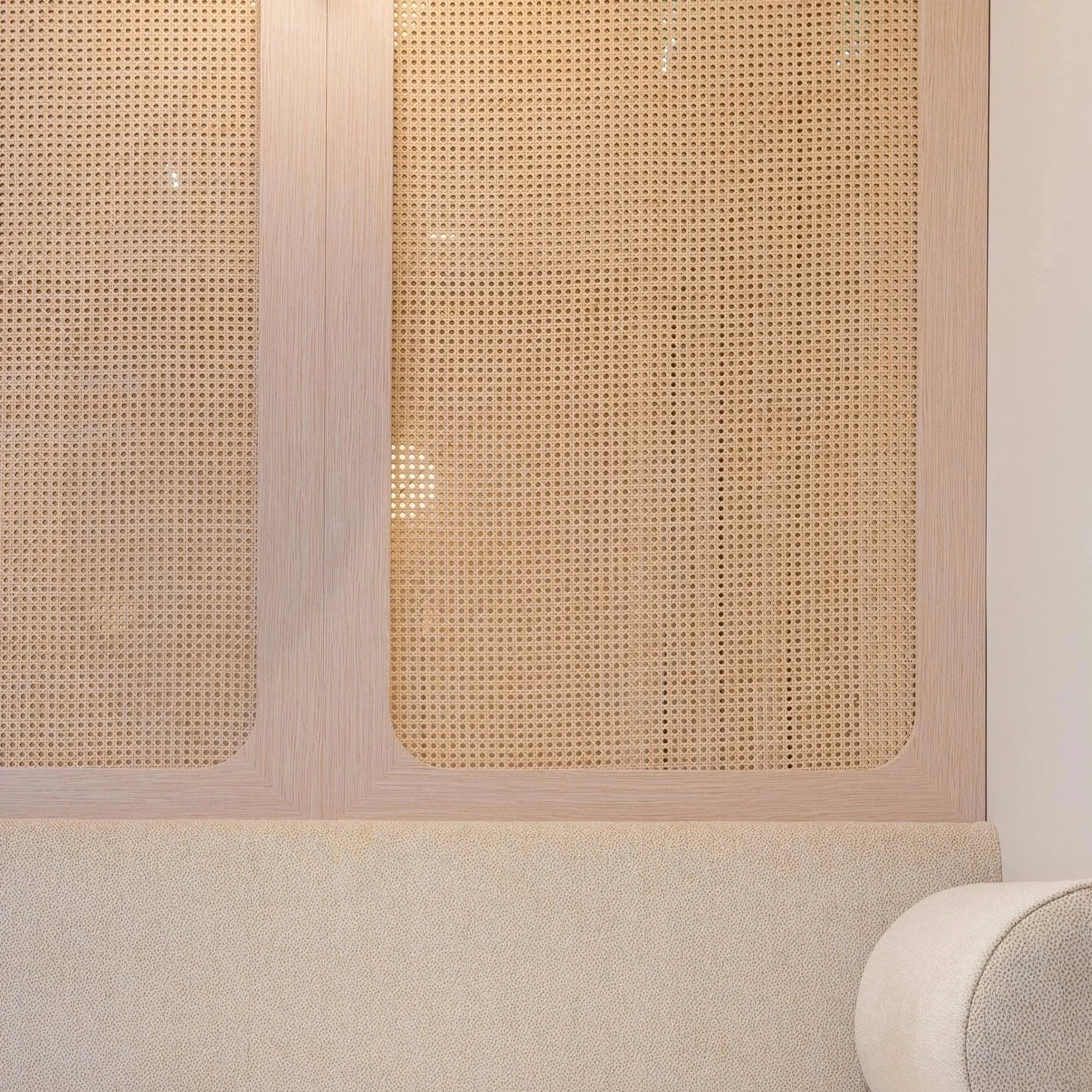 Close-up image of beige-colored surfaces with perforated patterns and possibly wooden panels.