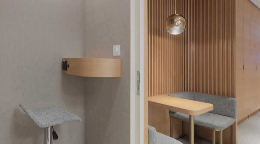 A small seating nook with a table, upholstered bench, and a table with a hanging spherical light fixture in a modern, wood-paneled interior.