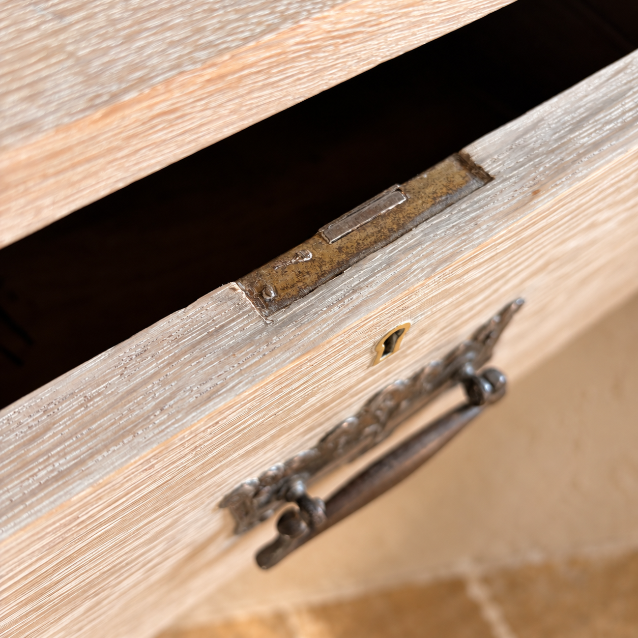 Brass Lock Plate on Open Limed Drawer.png