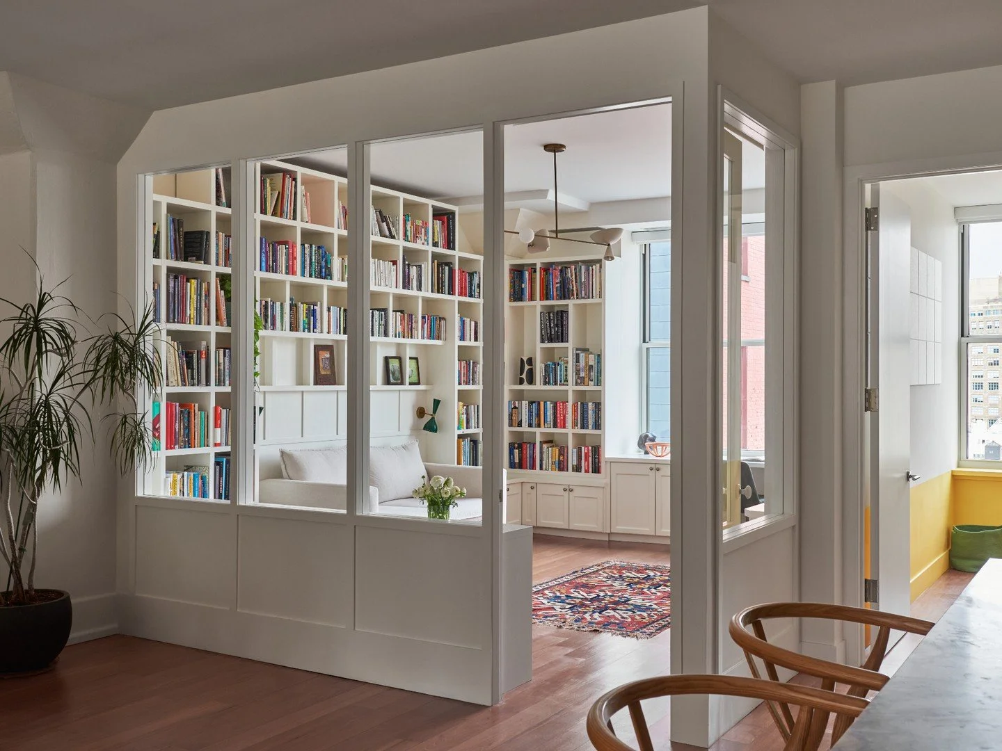 This room is all about light, warmth, and quiet separation.
Custom millwork, divided-light panels, and built-in shelving create a space that feels open while still offering privacy.

Architect &amp; Interior Designer: @studioofficina  Photographer: @