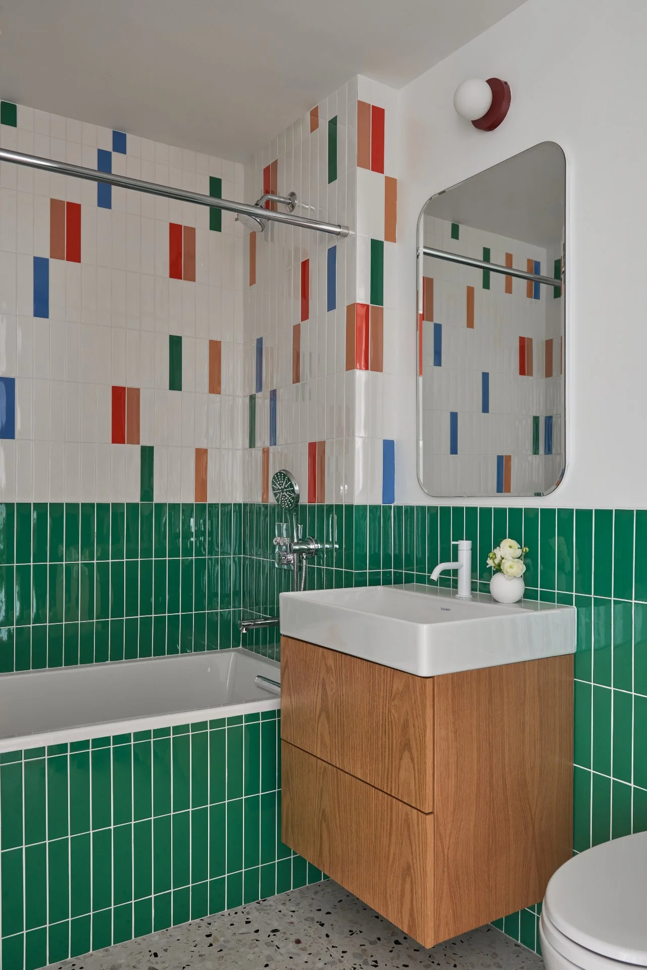 Bold colors meet careful craftsmanship in this bathroom.
Precise tile alignment, warm wood millwork, and durable finishes make a playful design feel clean and intentional.

Architect &amp; Interior Designer: @studioofficina