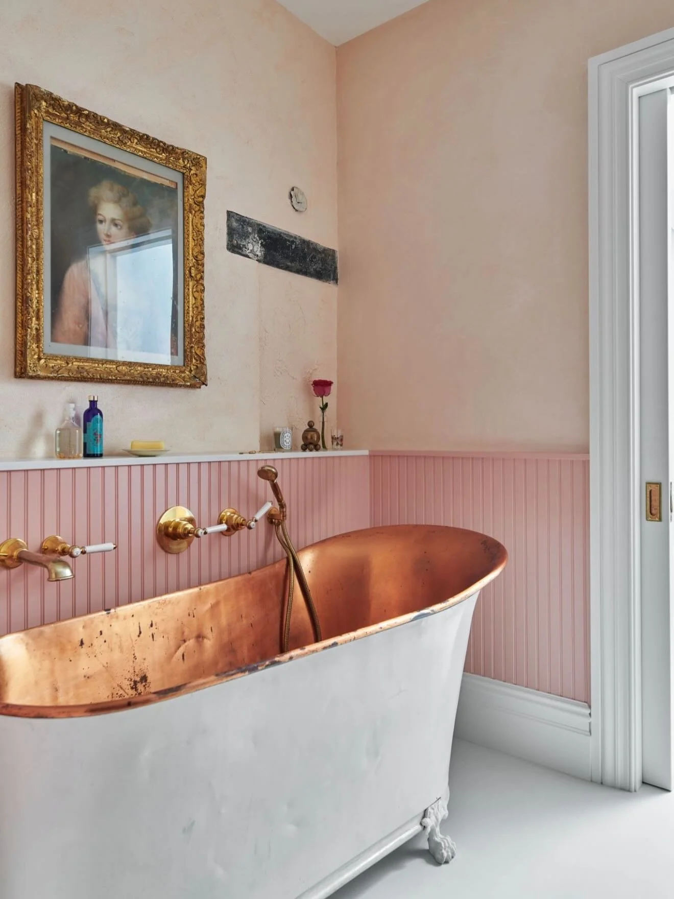 Soft tones, timeless details, and craftsmanship in every corner.

This bathroom blends vintage character with modern refinement, from the custom millwork and beadboard detailing to the warm brass fixtures and statement copper tub. 

At Sync Construct