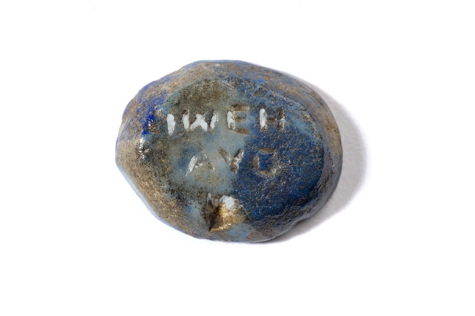 An oval blue stone with Greek letters engraved into the back of it.