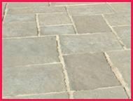 Close-up of a patio with rectangular stones in a grid pattern