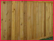 Wooden fence with vertical planks and a pink border
