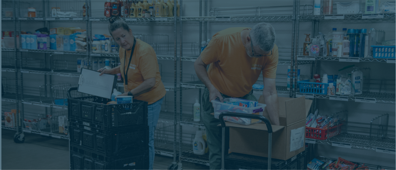 Two volunteers are in the choice market, grabbing goods to pack client's orders.