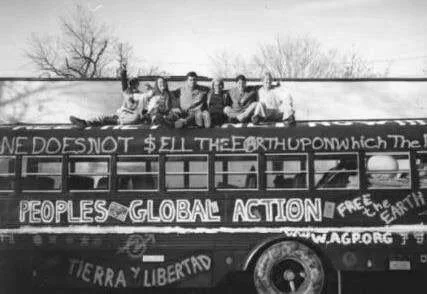 a hippie school bus decked out with anti-globalization messages