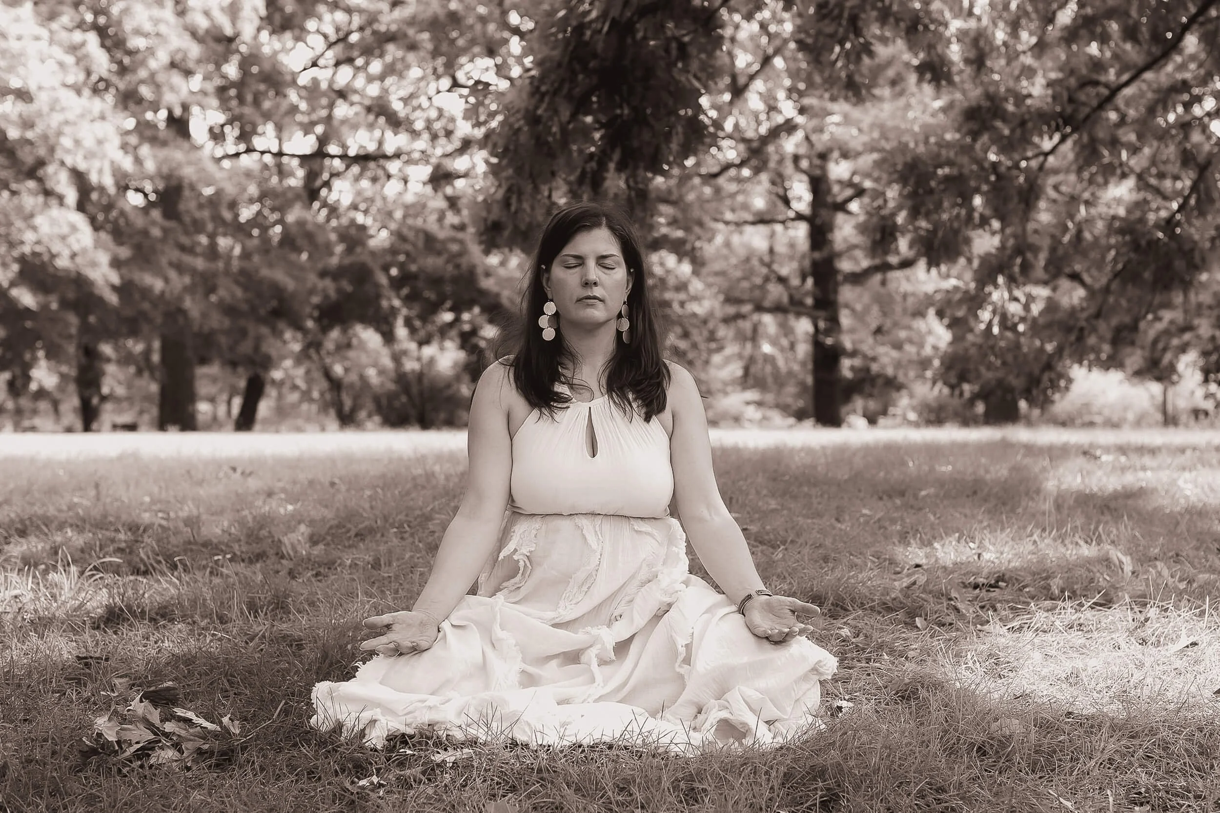 Kristi Amdahl meditating in the grass