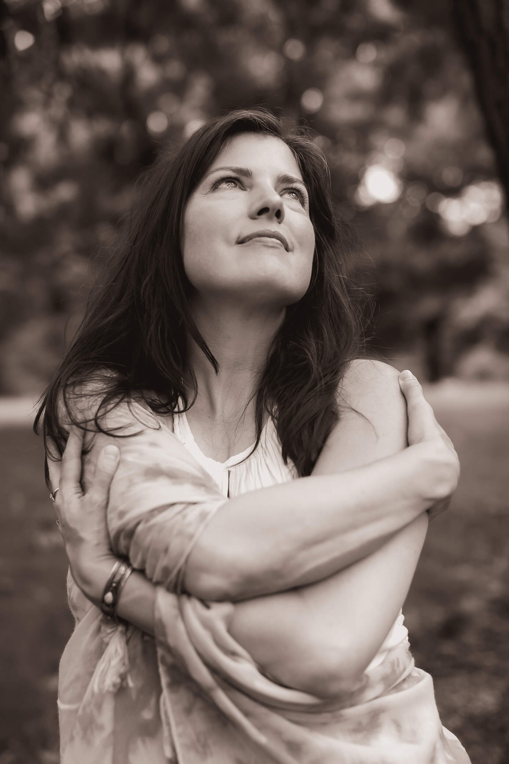 Kristi Amdahl hugging herself and looking upward