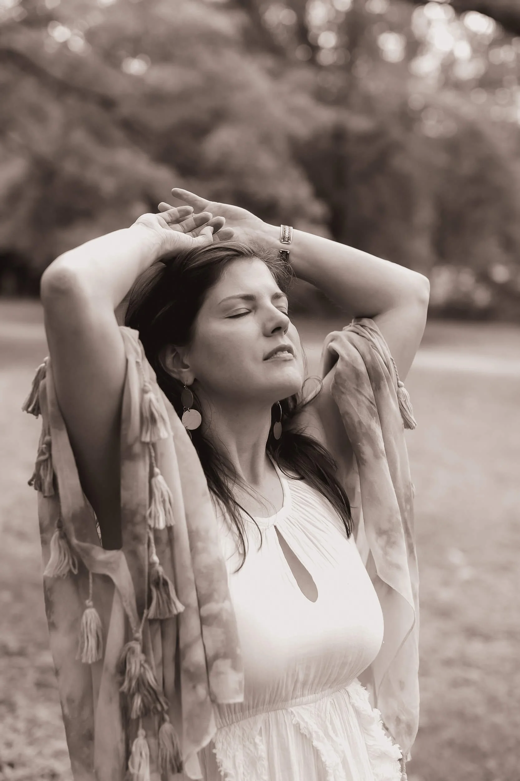 Kristi Amdahl, Wayfinder Coach, with her hands on her head and her eyes closed