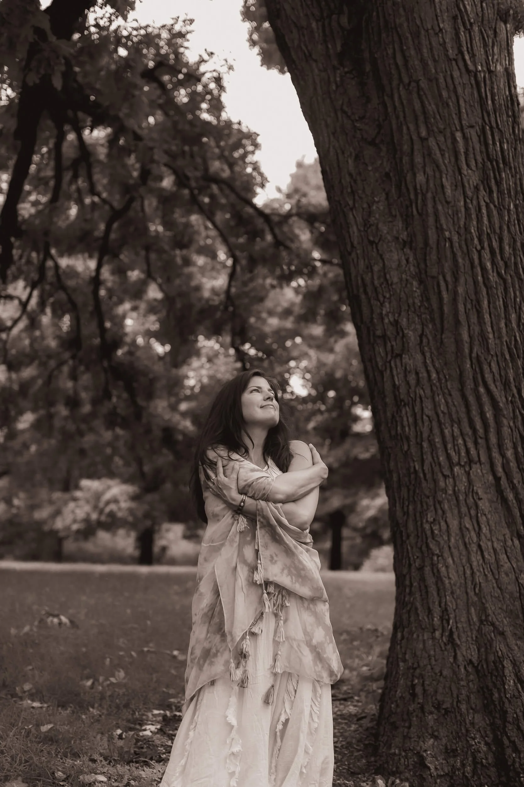 Kristi Amdahl looking gratefully at a tree and hugging herself