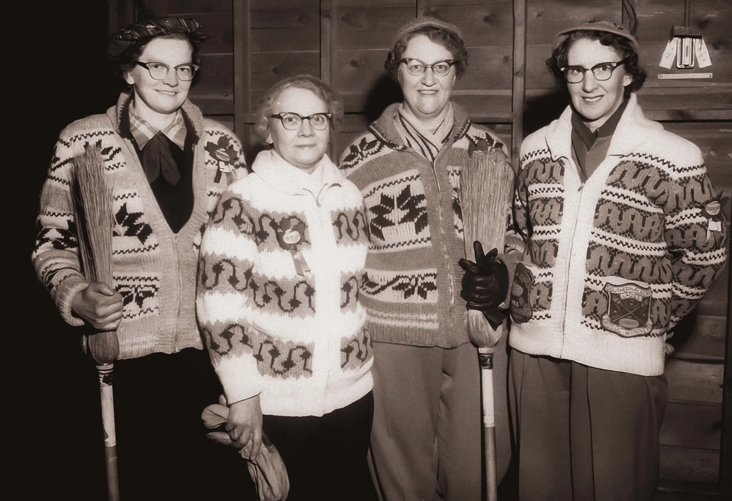 vintage photo of four witchy women holding brooms
