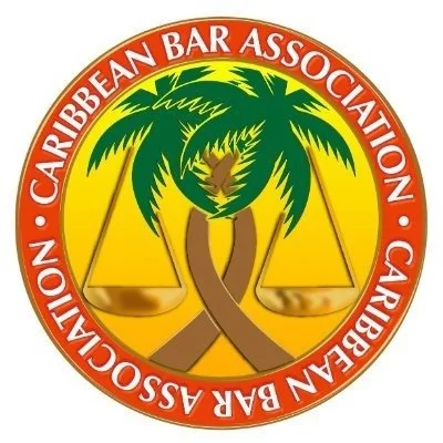Logo of the Caribbean Bar Association featuring two crossed palm trees and scales in the background, with a red circular border containing the association's name.