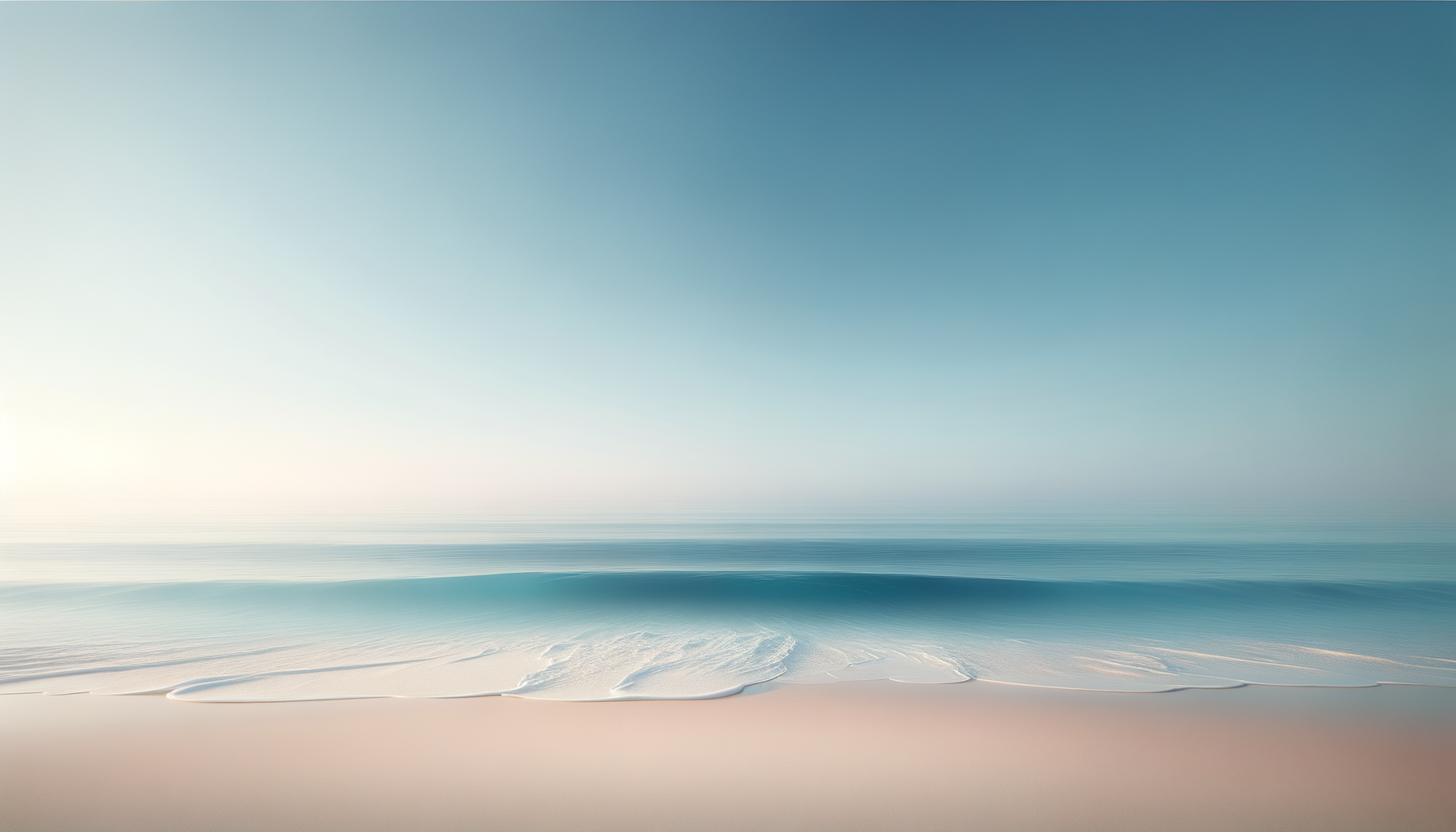 A calm ocean scene with gentle waves on a sandy beach, under a clear blue sky.