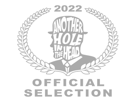 Design featuring a laurel wreath, a human head silhouette with the phrase "Another Hole in the Head" inside, the year 2022, a diamond shape, and the text "Official Selection."